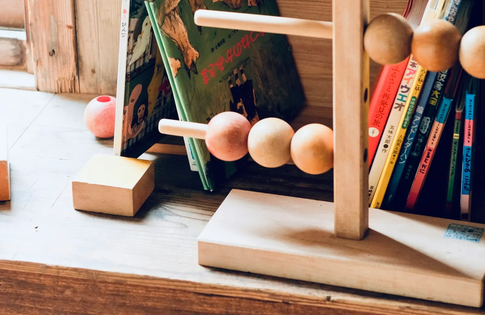 Un boulier de perles Montessori et du matériel en bois sur une table